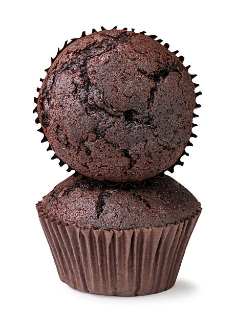 Chocolate muffins stand on each other close-up on a white background. Isolated
