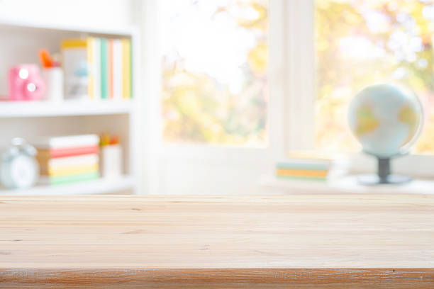 istock Empty wood table top on blurred background of classroom interior with book shelf and window sill. Original work - no AI used 2218215164