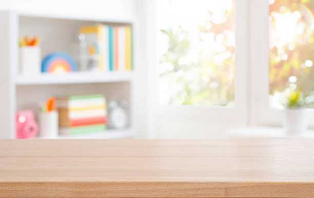 istock Wooden table top for educational purposes on blurred bookshelf and autumn window interior background. Original work - no AI used 2218215193