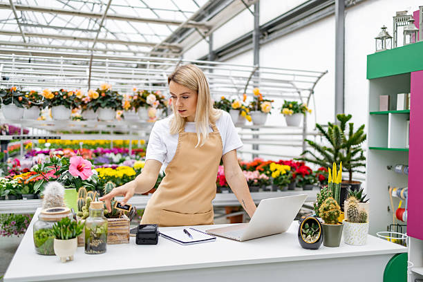 istock Florist Working at Counter in Shop 2218216883