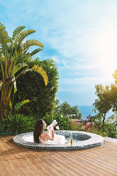 istock Young Woman Enjoying Foamy Soak in Private Spa 2218217285
