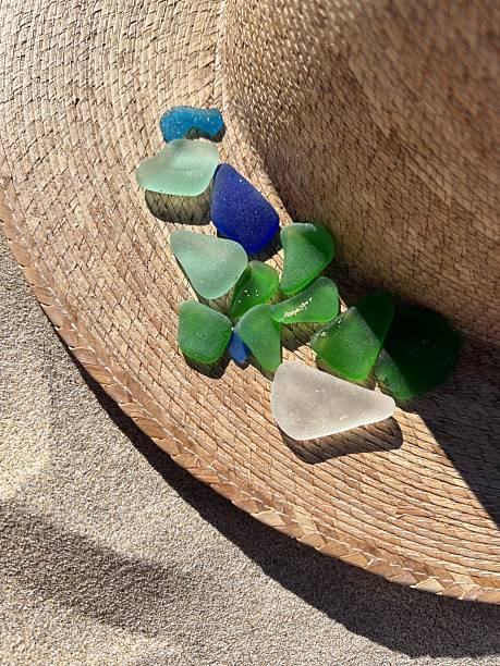 istock Vibrant sea glass on straw hat at beach. 2218218500