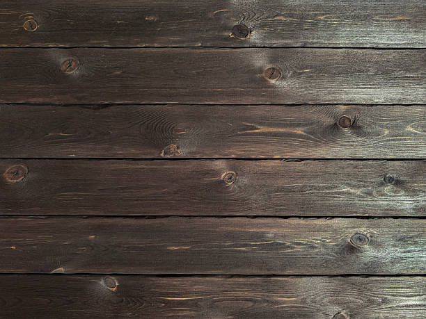 istock High-resolution texture of dark wooden planks with visible grain and knots 2218219931