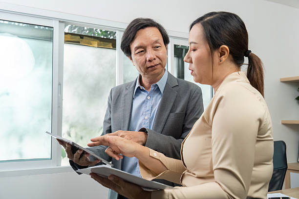 istock Business Presentation. Professionals discussing insights on digital devices in office. 2218220537