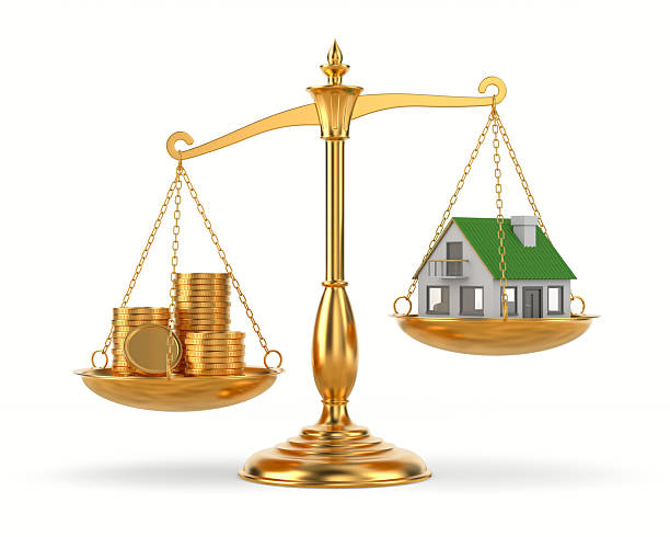 istock house and money on scale. Isolated 3D illustration on white background 2218220925