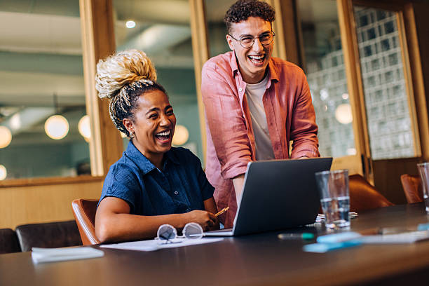 istock Colleagues enjoying a light-hearted moment while working together in the office 2218221150