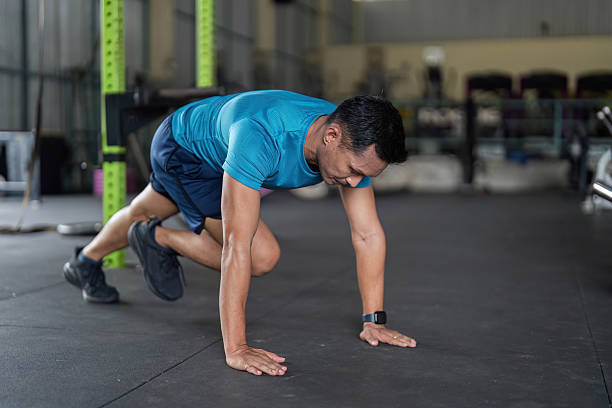 istock Fitness: Man Performing Mountain Climbers in Gym 2218221660