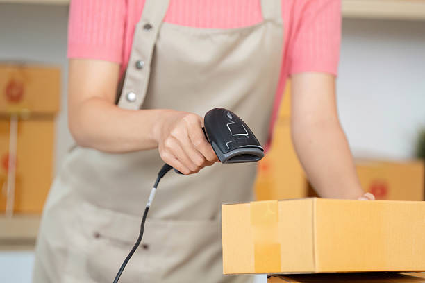 istock Small Business Logistics: Woman Scanning Package with Barcode Scanner 2218224425