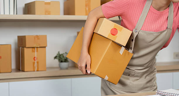 istock Small Business Logistics. A woman carrying multiple packages in a retail space. 2218224864