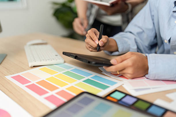 istock Creative Process in UX and UI Design. Designer working on a tablet with color swatches. 2218225548