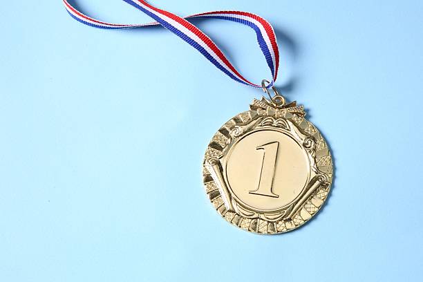 istock One golden medal on light blue background, top view 2218226069