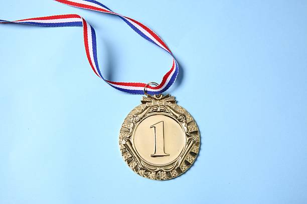 istock One golden medal on light blue background, top view 2218226082