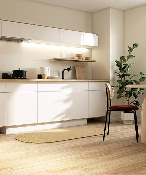 Modern, minimal cream kitchen and dining room with white cabinet counter wooden top, beige round dining table in sunlight from window on parquet floor for interior design decoration background 3D