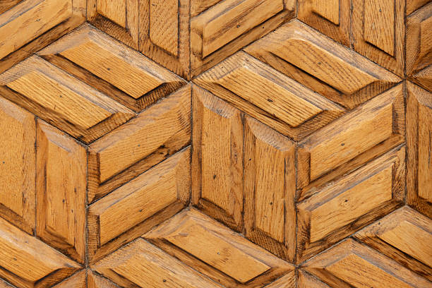Detailed close-up of a decorative wooden surface featuring a geometric pattern with rich wooden textures, emphasizing natural tones and craftsmanship. Ideal as a background or design inspiration
