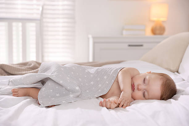 istock Cute little baby sleeping on bed at home 2218228847