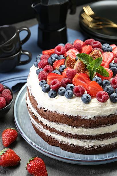 istock Delicious chocolate sponge cake with berries served on grey table, closeup 2218229052