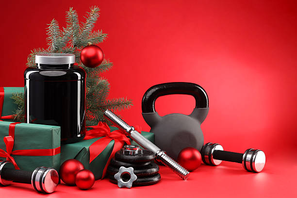 istock Dumbbells, kettlebell, container with supplement and Christmas decor on red background. Space for text 2218230653