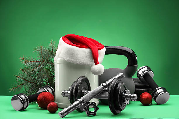 istock Dumbbells, kettlebell, container with supplement and Christmas decor on green background 2218230699