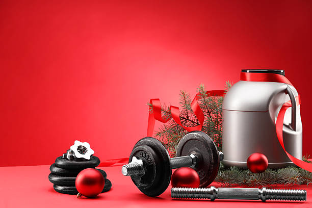 istock Dumbbells, container with supplement and Christmas decor on red background. Space for text 2218230726