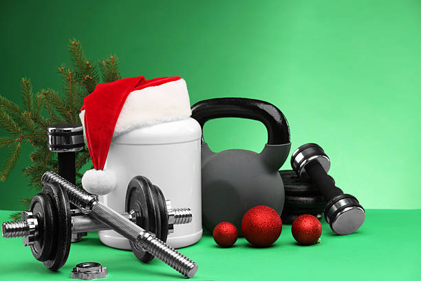 istock Dumbbells, kettlebell, container with supplement and Christmas decor on green background 2218230728
