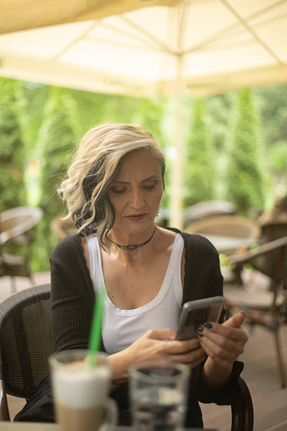 istock Woman in a cafe using mobile phone 2218234836