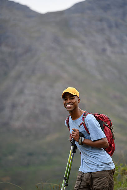 istock Happy hiker trekking through mountain trails with a scenic natural background 2218236262