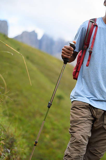 istock Solo hiker trekking through scenic mountain hillside with pole and backpack 2218236282