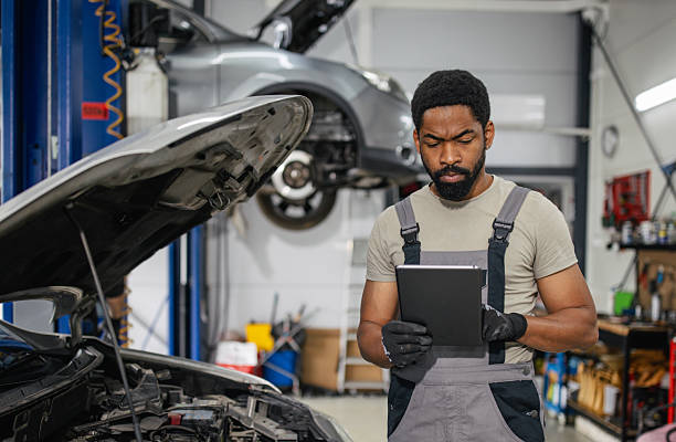 istock Mechanic engaged in diagnostics with focused demeanor 2218237604