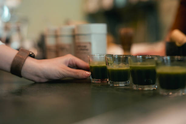 Barista mindfully serving a freshly whisked matcha at the counter. As the customer takes the first sip, they savor the earthy flavor and creamy texture. This moment captures the rise of functional drinks and plant-powered energy. Rooted in ritual and crafted with care, it's where artisanal prep meets the modern-day matcha lifestyle
