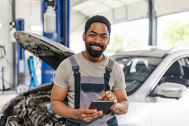 istock Confident Mechanic with Laptop at Car Hood 2218239211