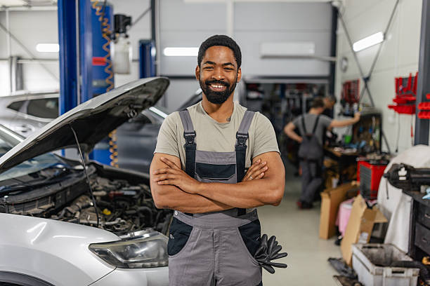 istock Mechanic posing confidently next to car 2218239807