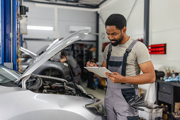 istock Mechanic checking vehicle status with clipboard 2218239918
