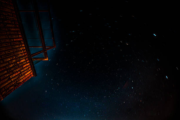 Stars in the sky near a brick wall