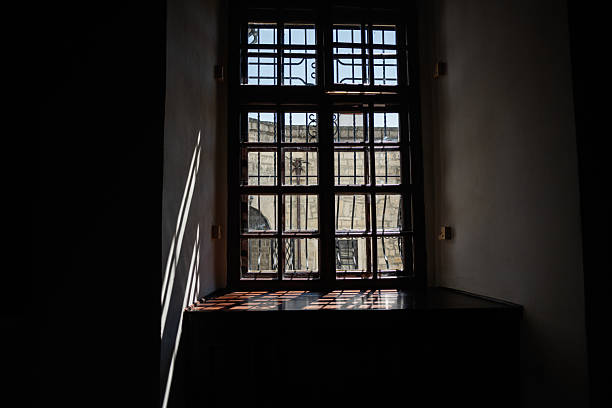 istock Sunlight streams through a closed wooden window casting intricate shadows indoors 2218243809