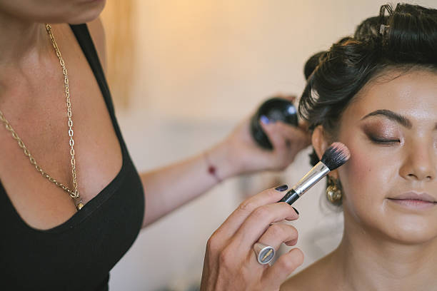 istock Makeup Artist Applying Blush On to Client 2218247625