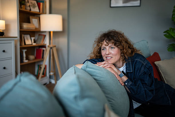 istock Serene woman relaxing on sofa: embracing tranquility at home 2218247792