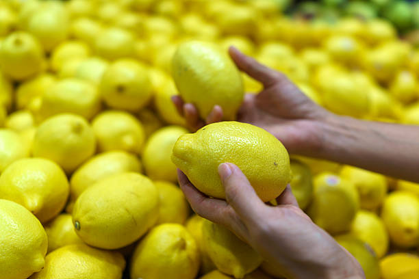 istock Picking Fresh Lemons at Market 2218250227