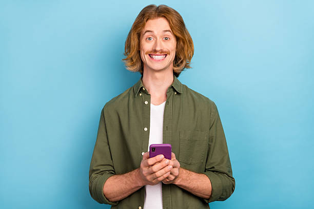 istock Portrait of attractive funky cheerful guy using device gadget app 5g smm isolated over bright blue color background 2218253239