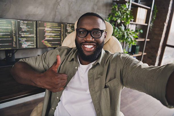 istock Self-portrait of attractive cheerful successful guy expert developing project showing thumbup at workplace workstation indoors 2218253454