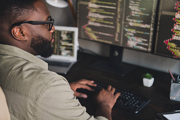 istock Profile side view portrait of attractive focused experienced smart skilled guy expert editing data at workplace workstation indoors 2218253554