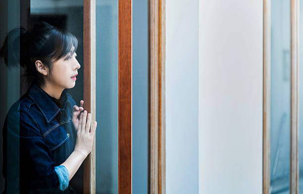 istock Woman see the scenery through the glass 2218255347