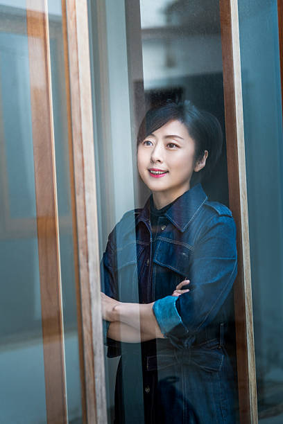 istock See a woman through the window glass 2218255398
