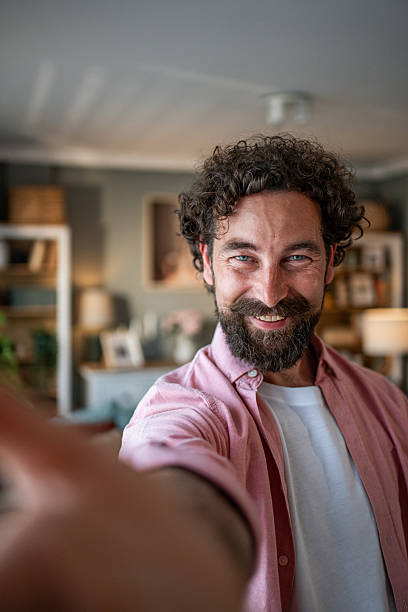 istock Happy bearded man taking a selfie at home 2218255450