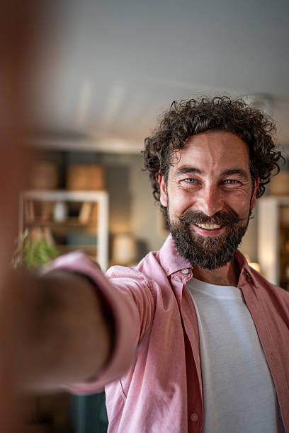 istock Happy bearded man taking a selfie at home smiling at the camera 2218255469