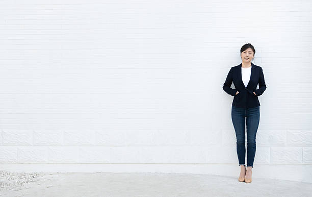 istock Confident woman standing with hands in pockets 2218255854