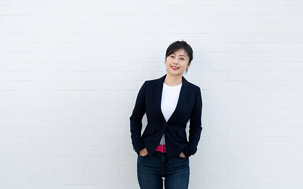 istock Confident woman standing with hands in pockets 2218255869
