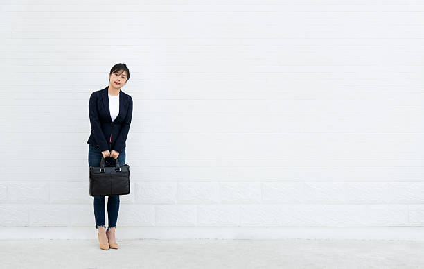 istock Confident woman standing and holding a briefcase 2218255959