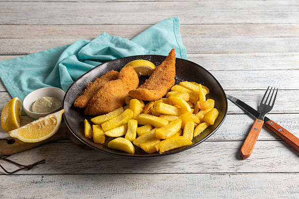 Delightful Fish and Chips Served With Lemon Slices