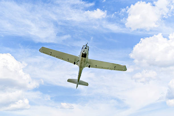 istock Light aircraft flying over blue sky 2218260595
