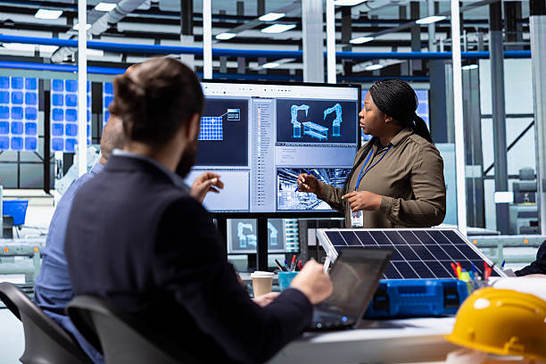 istock Shareholders collaborate on renewable energy investments, looking at data 2218262376
